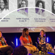 Four women sat on stage at a panel event.